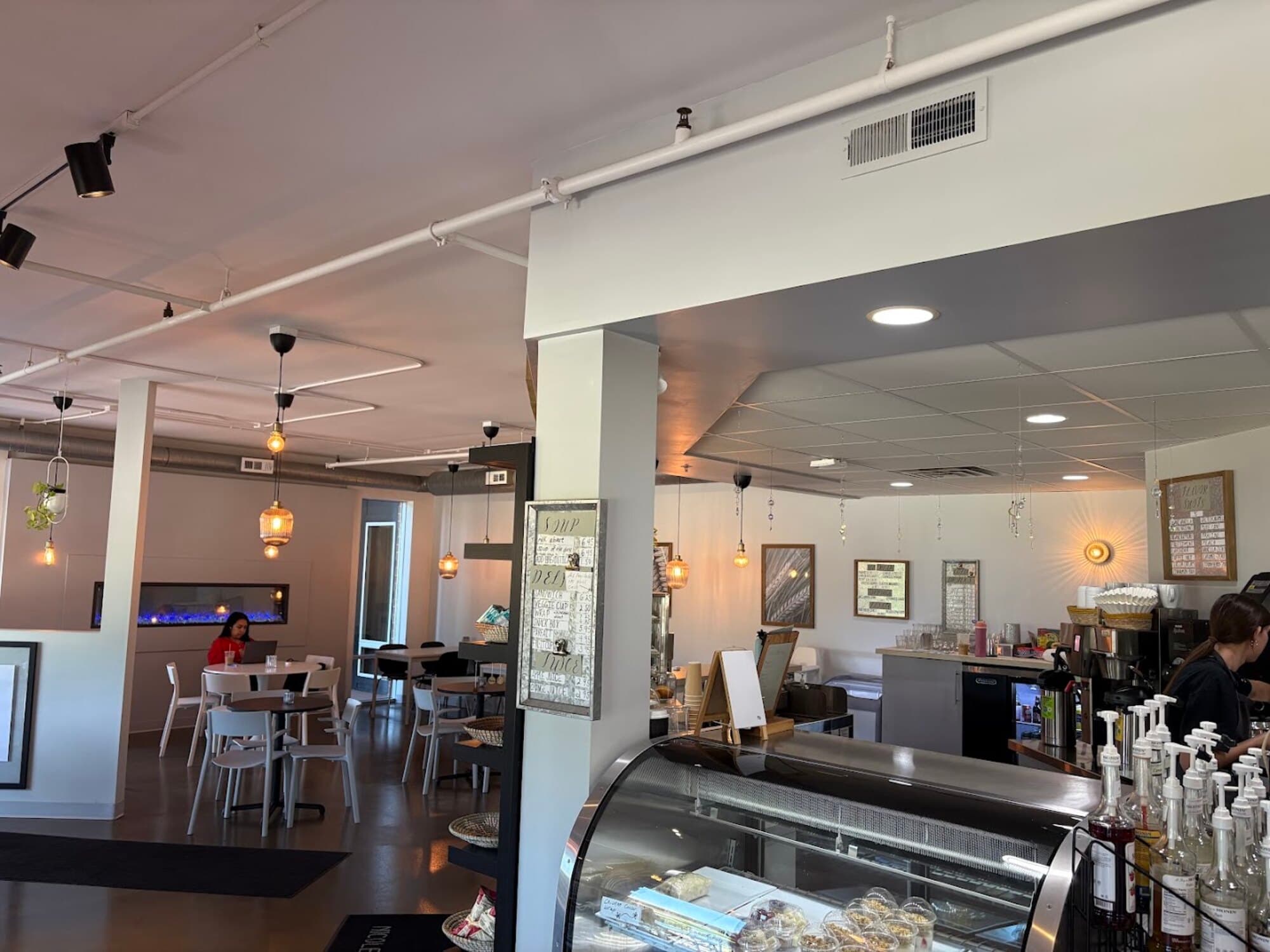 Inside Arise: the bakery case, the espresso bar and the dining room beyond.